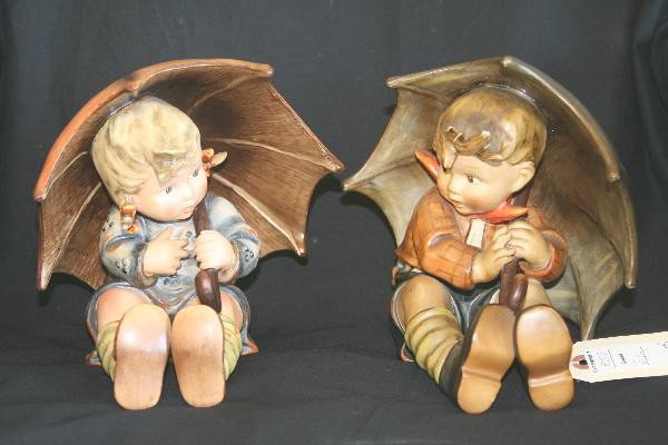 Hummel Umbrella Boy(152A) & Girl(152B): Each 7 3/4" tall, Girl has Large & Small V mark, Boy has small V with circle R. Free From Cracks Flakes and Chips. For Bigger and Better photos or information about consigning in our future events go 