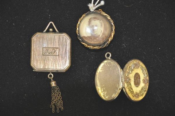 3 Early Lockets: 1" Square containing early photographs, marked Sterling. 1" oval gold colored locket, marked sterling. 1" round glass locket with early photograph. For Bigger and Better photos or information about co