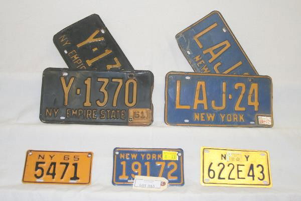 8 Vintage NY Car & Motorcycle License Plates: 3 Motorcycle plates, 1 dated 65, 4 Car plates, 2 dated 60 & 61, others blank. For Bigger and Better photos or information about consigning in our future events go to our website