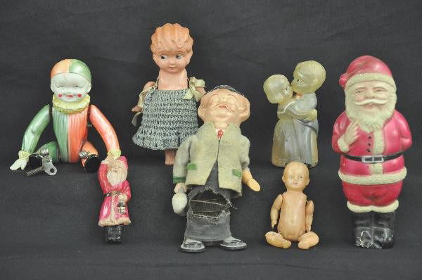 7 Early Celluloid Toys: 7" Wind-up tumbling Clown, functional, 1/2' crack near arm 1 side. 5" Dancing couple, functional with key. 4 1/2" Baby doll, no clothes, 6" girl doll, replaced clothes. 7 1/2" Santa Clause, damage to