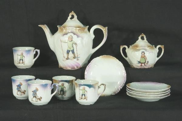 12 Pc. Bavarian Hot Chocolate Set: Designed by Mrs. Rose O'Neil Wilson, Teapot, Sugar, 5 cups & 5 Saucers all with children skiing motif, minor roughness and 1 saucer has a very small chip, will clean up nicely. For Bigger and Better p