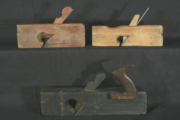 Three Early Wood Planes: 14" Block plane dark stained. Two 9 1/2" Block Planes. For Bigger and Better photos or information about consigning in our future events go to our website