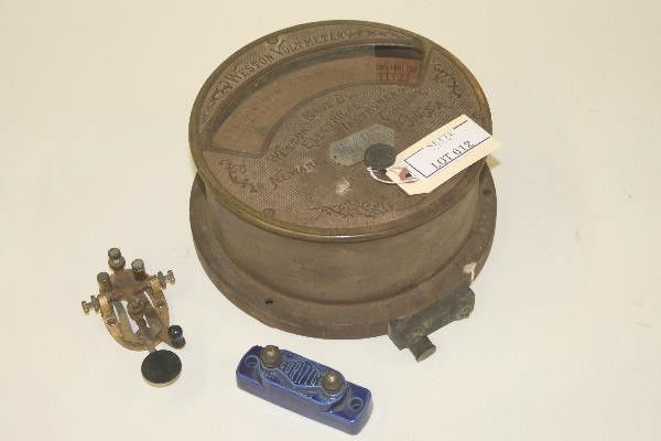 Early Brass Weston Voltmeter, plus: 9 1/2" Brass case, latest patent date 1897, glass dial cover broken, also includes Corwico ceramic insulator & brass telegraph key. For Bigger and Better photos or information about consigning in our