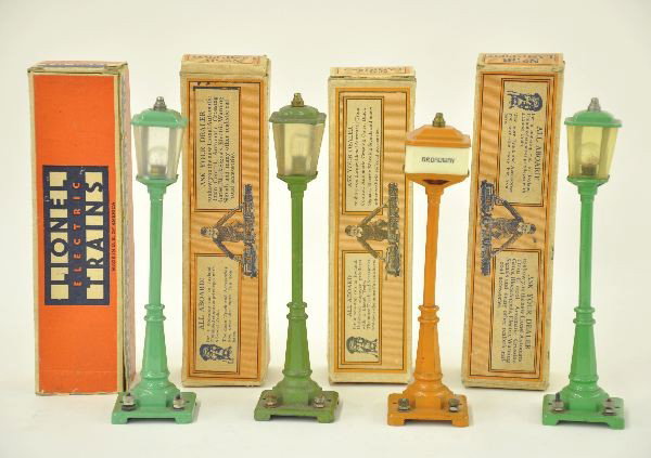 4 Boxed Lionel Lampposts: 3 #56 Lamps, two are 45N green, one is olive; 57 Broadway and Main Lamp, original boxes, one 56 missing flaps 1 side. Shows Light Playwear.