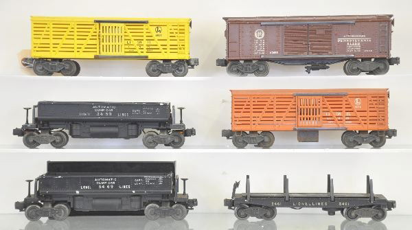 6 Lionel Freight Cars: 6656 Stock Car; 2458 PRR Boxcar, 3459 Coal Dump; 3656 Operating Stock car, car only; 3469 Coal Dump with bin & coal; 3461 Lumber car, no load, all show Moderate Playwear.