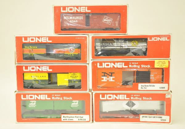 7 Boxed Lionel O-gauge Cars: 6-9133 Burlington flat car with vans; 9710 Rutland; 6-9772 Great Northern boxcar; 6-9731 Milwaukee boxcar; 6-9149 C.P. Rail flat car with vans; 6-9605 New Haven Hi-cube boxcar; 6-9154 Borden plated ta