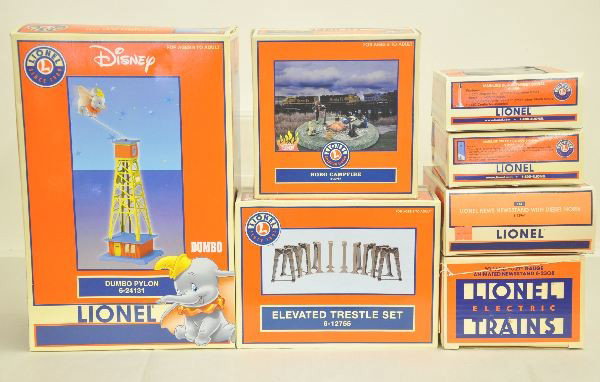 7 Boxed Lionel Accessories: 6-32987 Hobo campfire; 6-12755 Elevated trestle set; 6-24131 Dumbo pylon; 6-12961 Lionel newsstand with diesel horn; 6-2308 Animated newsstand; 6-24101 Mainline color position signal; 6-14099 Mainline