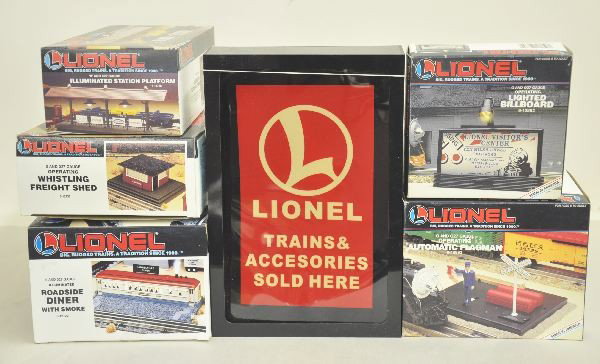 6 Boxed Lionel Accessories: 6-12722 Illuminated Roadside Diner with smoke; Lionel Trains Sold Here Lighted sign; 6-12882 Lighted Billboard; 6-12892 Automatic Flagman; 6-12748 Illuminated Station Platform; 6-12737 Whistling Freig