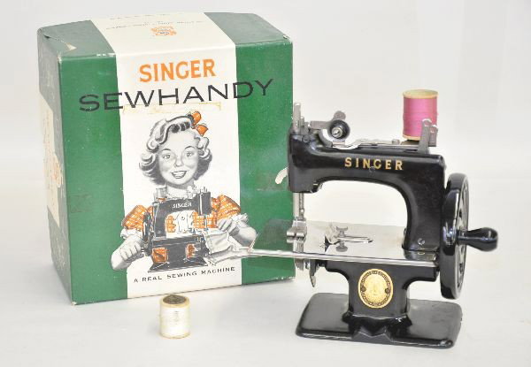 Boxed Early Model 20 Singer Sewing: Earlier version of previous lot, black with brass plate, appears complete a few thread samples, nice original box with packing, shows light use.