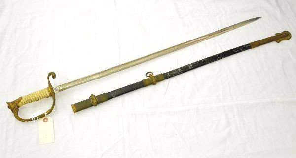 1852 Navy Cadet Officers Sword: 35" brass sword, with brass guard and coated leather grip, dolphin heads on quillon finial at the tip of upper guard, Design in use from Civil War to WW II. Made by Browning King and Company, New York