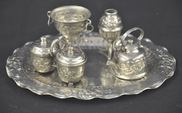 Lot of Victorian Miniatures: 6 1/2" long oval platter, with flower design, tea kettle with top, ice bucket incomplete, condiment set, vase, 2" vase a few minor corrosion spots on tray otherwise, shows signs of use. Cute.