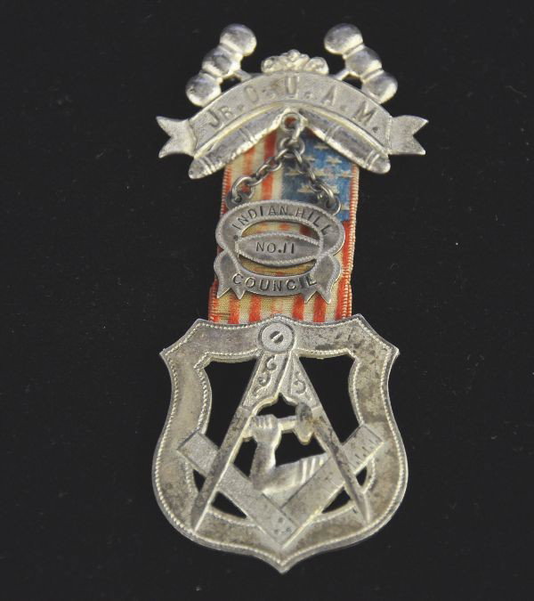 Masonic Pin Badge: Pin badge with ribbon, Indian Hill Council #11, top embossed "Junior OUAM", stamped silver on back, with makers mark. Flag ribbon shows wear. Unusual.