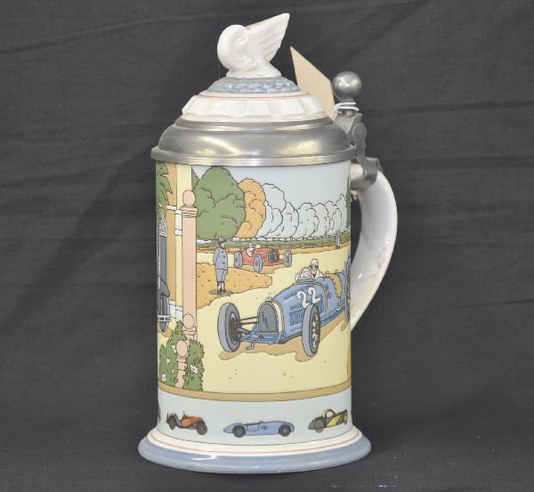 Mettlach Bugatti Centennial Beer Stein: Porcelain and pewter, 1/2 liter stein with colorful automotive motif showing earliest Bugatti models up to about 1965. Clean with no visible damage, Nice example.