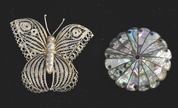 Two Mexican Silver Broaches: 2 1/2" pierced butterfly and 2" round sterling broach with mother-of-pearl inlay in floral pattern, signed CLO. Has other maker's marks
