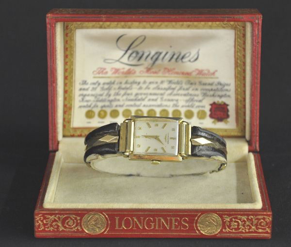 Longines Gold Wrist Watch: Circa 1955, gold and leather band shows wear, case marked KNE 14 K Mechanism functional, original box
