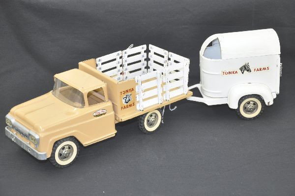 1959 Tonka Farms Truck with Trailer: Pressed steel, overall length 23". Clean and shiny, with strong decals, original trailer missing horses, shows light to moderate playwear.