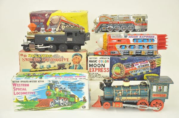 Four Battery Operated Tin Train Toys: Battery Operated San Bulldog Smoking Locomotive in original box, heavy gauge steel. Battery operated Modern Toy Western Special Locomotive with puffing noise, whistle, flashing light and head light in