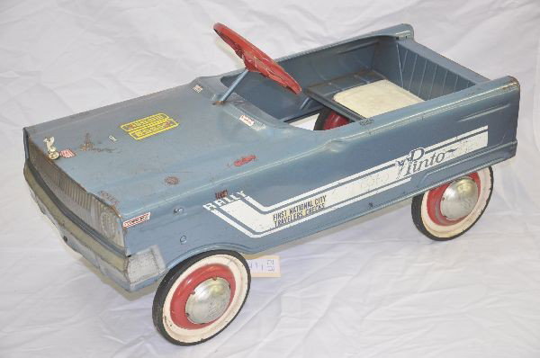 Murray Ford Pinto Pedal Car: Circa 1970's, painted pressed steel 31" long, unusual model, has original rally stripes, clean but has added decals and graffiti. Shows moderate playwear.