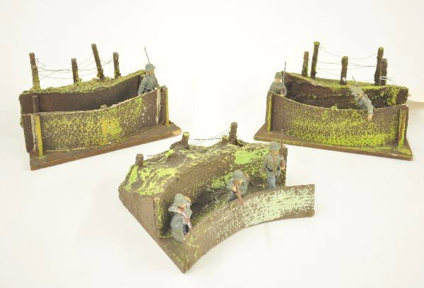 Three Piece Awesome Hausser Trench and Figure Lot: Three 7" trench and curved barbed wire sections. All in matching green paint with 6 Elastolin figures, showing minor wear. Trenches are unusually clean and bright.