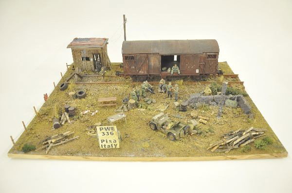 Fantastic Military WW II Diorama: 24" x 19" museum quality scene at POW camp in Pisa, Italy. Displays railway car with prisoners in uniform, American guards, super detailed. Realistic portrayal which makes you feel like you are actual