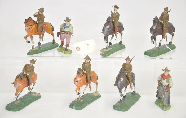 14 pc Large Trico Figures: Unusual large size figures includes two cowboys, mounted British squad with bugler with missing horn, officer and four mounted infantry. All show age cracks and chips, especially the bases but paint i