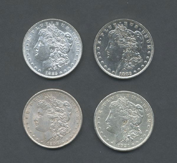 Four Silver Morgan Dollars: 1882 O, 1885, 1898 and 1921 in grades of XF to AU. One coin may have been cleaned, examine carefully.