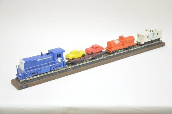 Rare Marx Prototype Display Set: Set Number 7360 includes scarce MP diesel with decals, Erie auto loader, decaled Gulf tank car and decaled Missouri Pacific Caboose. All on roadbed track, factory mounted to display board. WOW