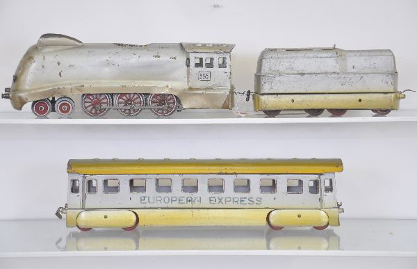Unusual European Streamline Train Set: O-Gauge, possibly early Distler. 565 Cock-of-the-North style loco, three rail, tender, European Express coach, painted and stenciled tin. Condition: shows overall even wear, cast drivers, plastic trai