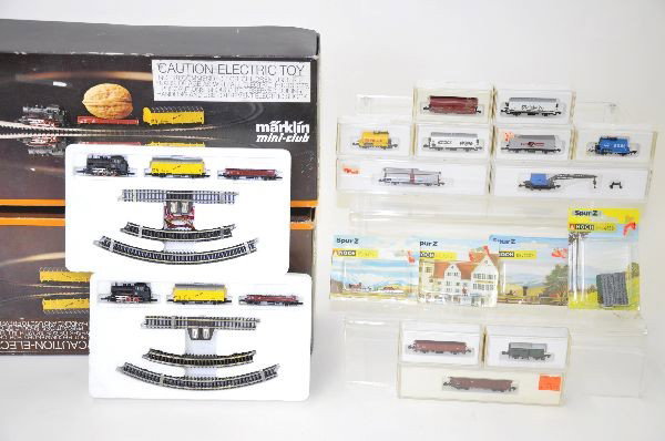 Marklin Z-Gauge Lot: Two 8907A starter sets, one missing transformer with some extra track. 8609 baggage car, 8622 open car, 8668 coal car, four Noch Figure lots. All original boxes, shows light playwear. C7-8