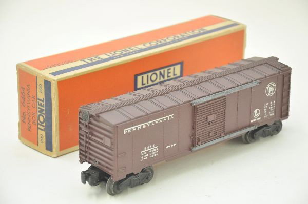 LN Boxed Lionel 6464-200 PRR Boxcar: Type 2A body, nice matte patina, with clean heat stamp lettering, one truck has tab end coupler, crisp original box. Otherwise, shows light playwear. C8