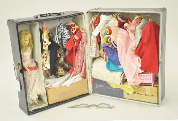 Barbie Doll With Case and Wrist Watch: 1961 doll case filled with clothes and accessories and a 1965 Barbie doll. Barbie has original eyelashes and the hair appears to be original. Minor discoloration. Case has some rust on latch and wear 
