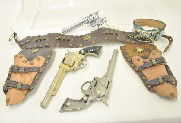 Cap Gun and Holster Lot: Cowboy double holster set. One gun is missing plastic grips and one gun is functional. Original holster set missing bullets; Nichols Stallion 38 with original bullets and empty cap box, functional; Da