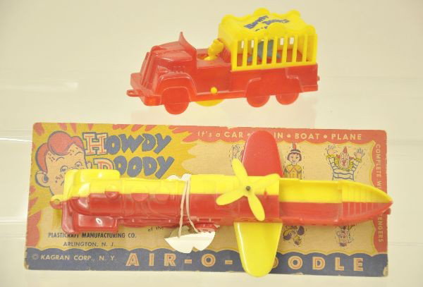 Two Scarce Howdy Doody Toys: Scarce Kagran-Air-O-Doodle with scarce original card. Characters are unpunched. Made of hard plastic, 7 1/2" long. Companion piece made by Plasticraft is the Howdy Doody Circus Truck with gorilla cage