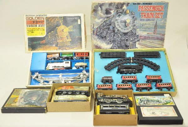 Four Boxed Japanese Tin Train Toys: TN Santa Fe cable train, TN Central Line steam set cable train, Yone Japan Golden Flyer S-Gauge size with track, box incomplete; Haji passenger train with lights. Includes locomotive, UP tender and 6 