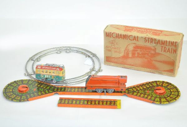 Two Train Toy Sets: Unusual Mettoy Mechanical Streamline train. Litho tin loco with nice track graphics. Mechanism functional. Runs on a figure eight track, like new. C8-9 Original set box has light staining; Pre-war Jap