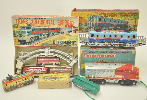 4 Boxed Japanese Tin Train Toys: Romance Interurban 5 1/2" long; Electric outline locomotive 13" long with insert; Santa Fe battery diesel 10" long, one drive wheel warped and untested; Trans Continental Express Set by Yone Japan, wi