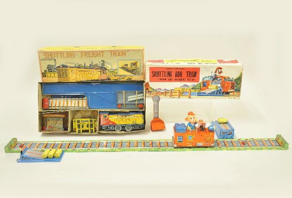 Two Boxed Shuttling Train Toys: Alps shuttling freight train complete with all accessories and some wrapping, original box with inserts. Diesel shows light battery damage, contacts intact; Yone Japan shuttling dog train complete wit