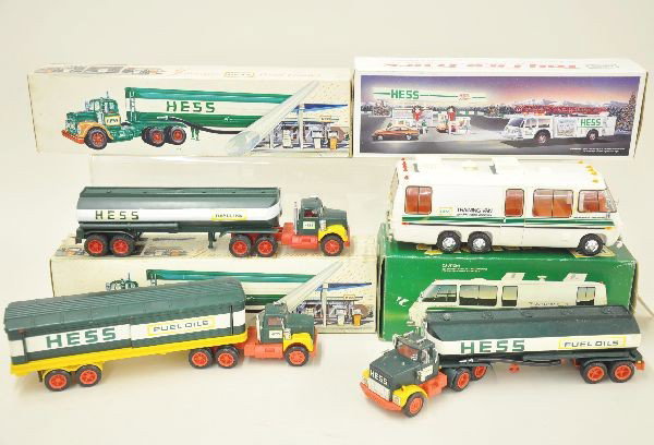 Four Early Hess Trucks Plus: 1968 Amerada tank truck with box, 1972 Marx tanker truck with box, 1975 box truck with drums, 1980 training van with box. Plus 1989 fire truck, mint in box. Otherwise, shows light to moderate wear, bu
