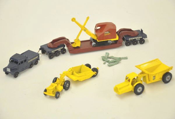 4 Matchbox Major Packs: #MP10 dinkum dumper, MP1 scraper, MP5 Scammel transporter, MP4 Bucyrus Shovel, treads in pieces but included. All have light axle rust. Otherwise, should clean to excellent plus to like new. C7-8