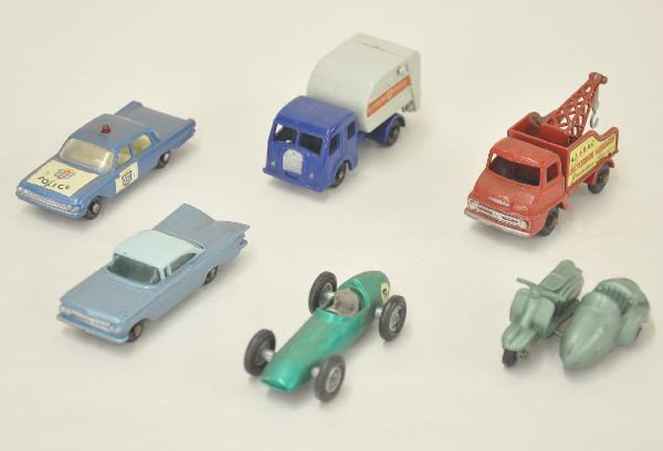 6 Matchbox Vehicles: Early 1960's production. #36 Lambretta motor scooter with side car; #19 Austin Martin, driver missing head; #55 police car, decals 95%; #13 breakdown truck, strong decals; #15 garbage truck; #57 Chevr