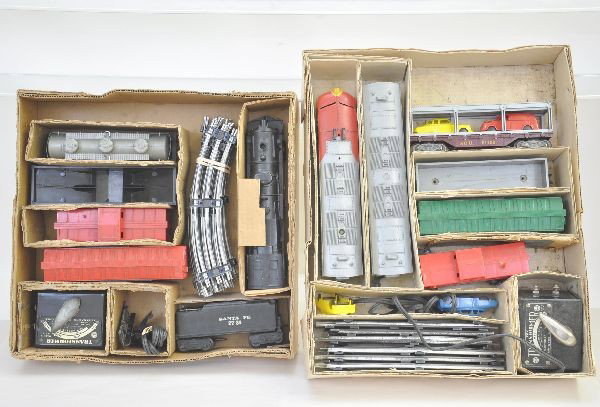 Boxed Marx Sets 41822 and 36265: 41822 includes 1095 Santa Fe F9 AB diesels (has repaired chip in back of cab), auto loader, gondola, NYC boxcar, 1977 caboose, set box top rough. Set 36265 includes 1829 steam loco, 2731 tender, UTLX 