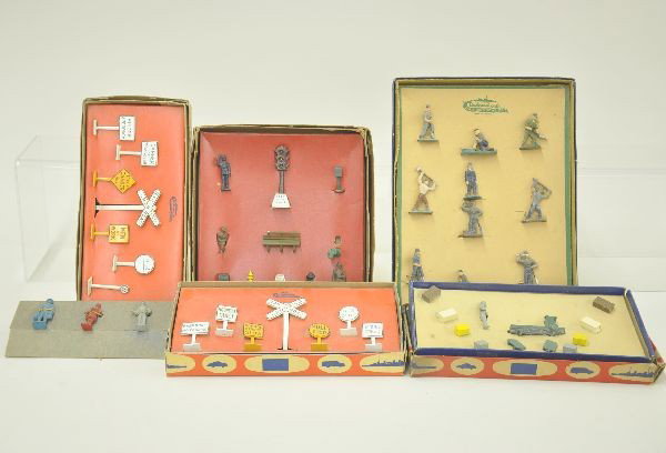 Six Boxed Authenticast Figure Sets: X-1 and X-2 sign sets, R152 freight station platform accessories; 823 construction crew; M80 street and sidewalk accessory set, bench has one broken board; miniature Automobile Association promo hot d