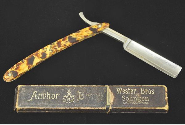 Boxed Anchor Straight Blade: made by Webster Brothers, Solingen, Germany. Nice mottled handle blade marked Brown Razor Company, Little Valley, New York. Original box shows some wear. Knife is in beautiful original condition.