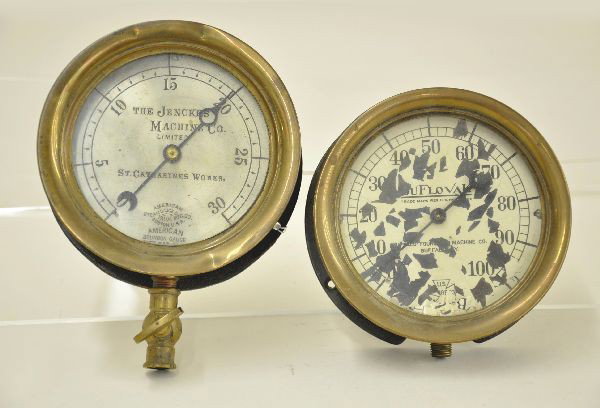 Two Early Locomotive Steam Gauges: Brass low pressure gauge by the Jenckes Machine Company dated 1903, presents well. The second is US Gauge Company for the Buffalo Foundry and Machine Co. Enameled face is heavily flaked.