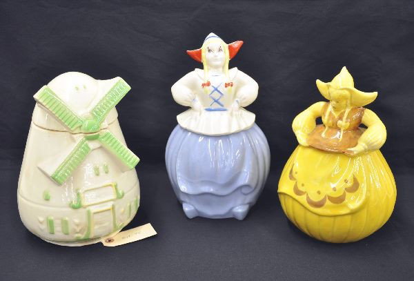 Three Figural Cookie Jars: All are Dutch related, tallest is 12". Includes two Dutch girls and a windmill. Two are unmarked, one has logo on bottom which is unreadable. Minor crazing and hairline cracks on yellow jar. Otherwise