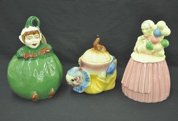 Three Figural Cookie Jars: Tallest is 12". Includes Shawnee circus clown with seal; Pastry Guild balloon vendor, small flake on lower edge; Elf, bottom marked copyright 1952. All show light wear.