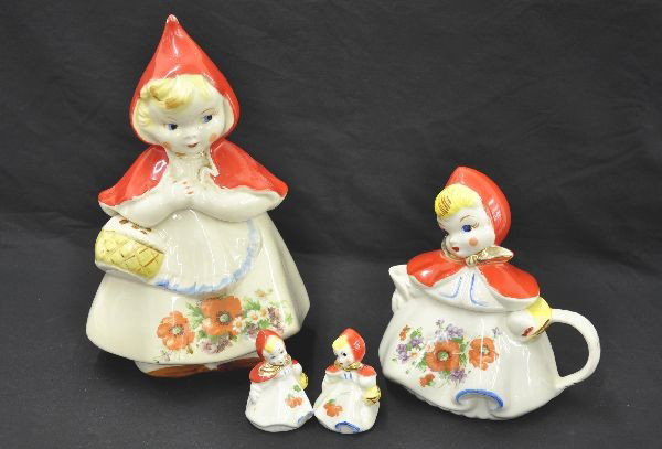 Scarce 4 pc Little Red Riding Hood Set: Tallest is 13". Cookie Jar has title and marked USA, has 3" hairline on body and minor paint wear on hood; tea pot, salt and pepper shakers, missing one cork, salt shaker has chip on dress. Unusual to