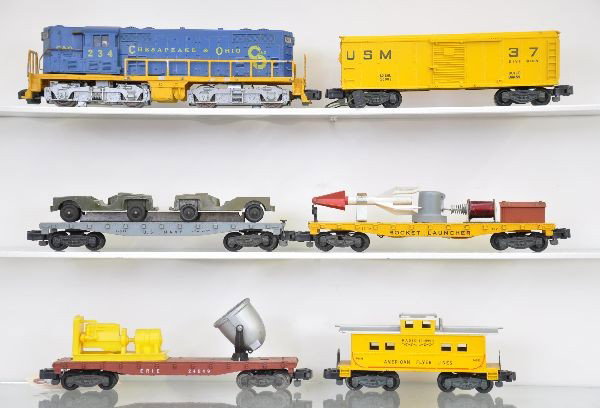 American Flyer S-Gauge The Defender Set: 21234 C&O GP7 diesel, frame paint flaking 20%; 25056 USM 37 rocket launcher and boxcar set; 24557 Navy flat with Tootsietoy Jeeps; 24549 search light car; 24631 caboose. Otherwise, shows light to mode