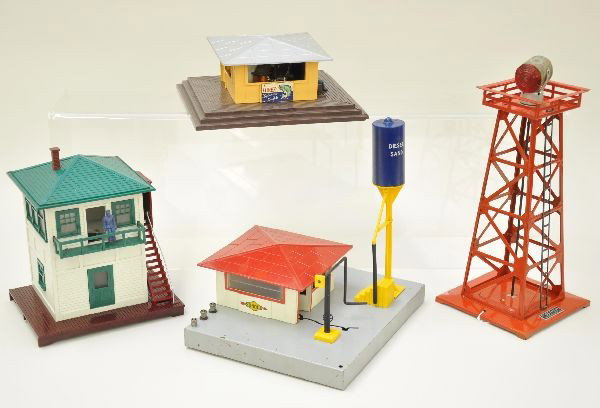 Lionel Accessories: 494 beacon, 445 operating switch tower, 415 diesel fueling station, missing two window inserts, 118 whistling news stand, missing one window insert, 70 yard lamp. All show light to moderate playwear. 