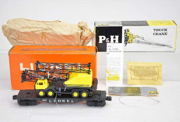Mint Boxed Lionel 6828 Flat With P&H Crane: Clean and complete with sealed packet, instructions and brochure. Inner box and wrap clean and crisp. Flat is unrun. Picture box strong, factory new. C9